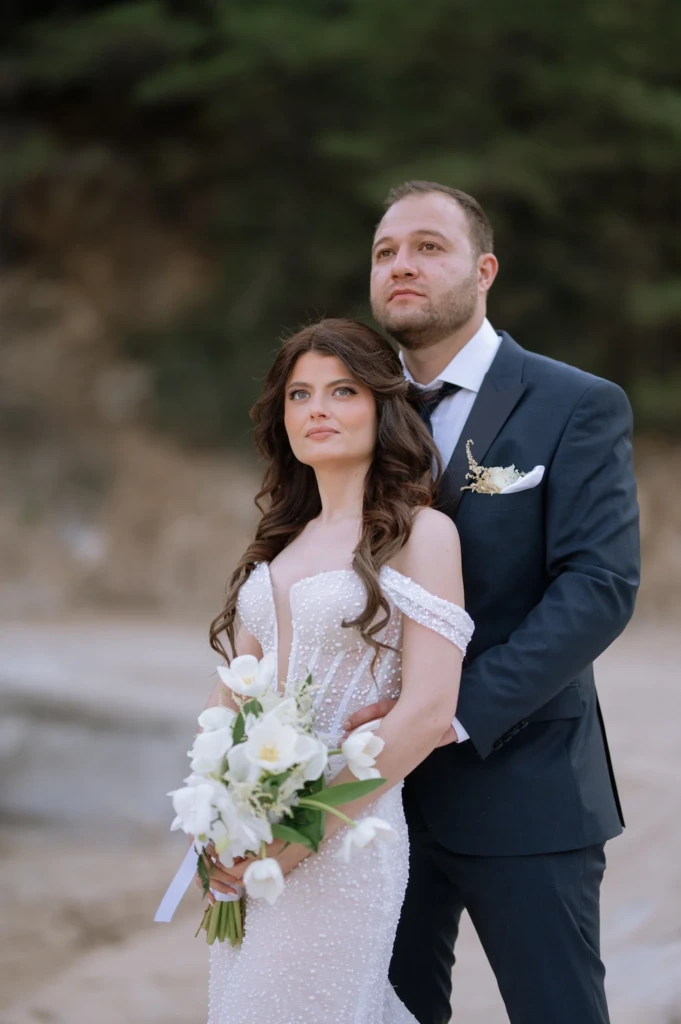 Marina and Giorgos embracing as newlyweds at their ceremony