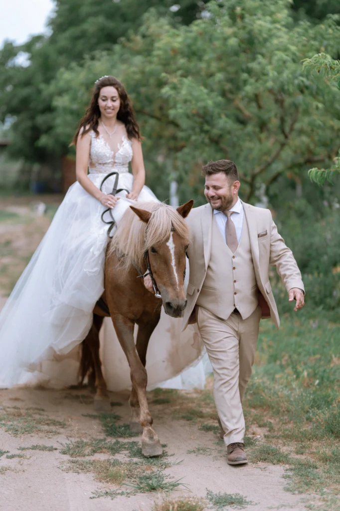 Elena and Vasilis walking together with their horse along a country path