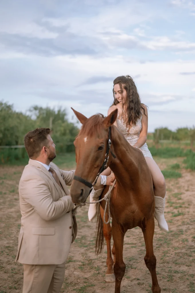 Elena riding a horse led by Vasilis along a countryside path