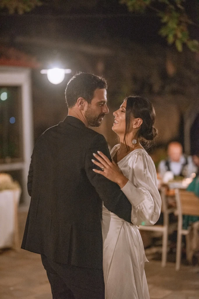 Hara and Giannis embracing as newlyweds at their island wedding in Thassos