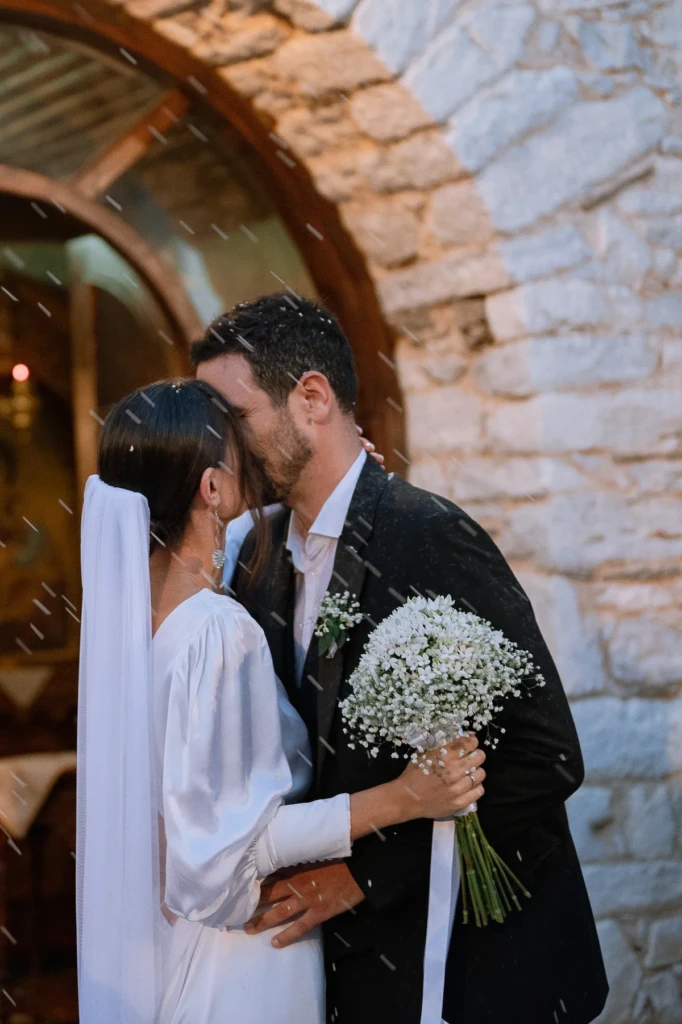 Hara and Giannis exchanging vows by the sea at Psiliammos beach