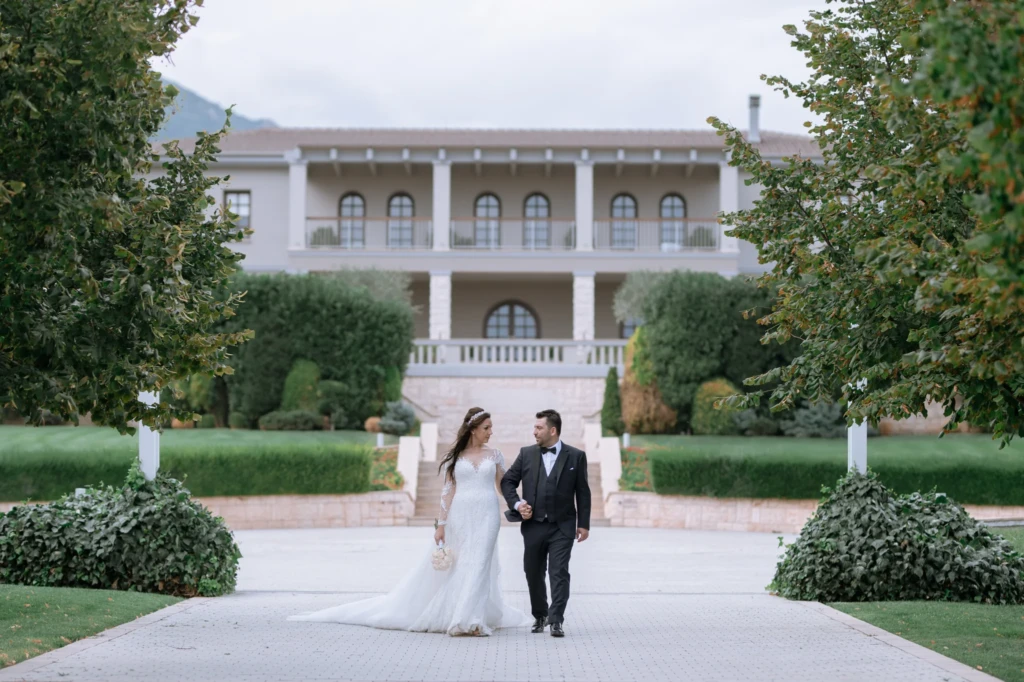 Loukiani and Giorgos walking hand in hand through the gardens of Ktima Biblia Chora
