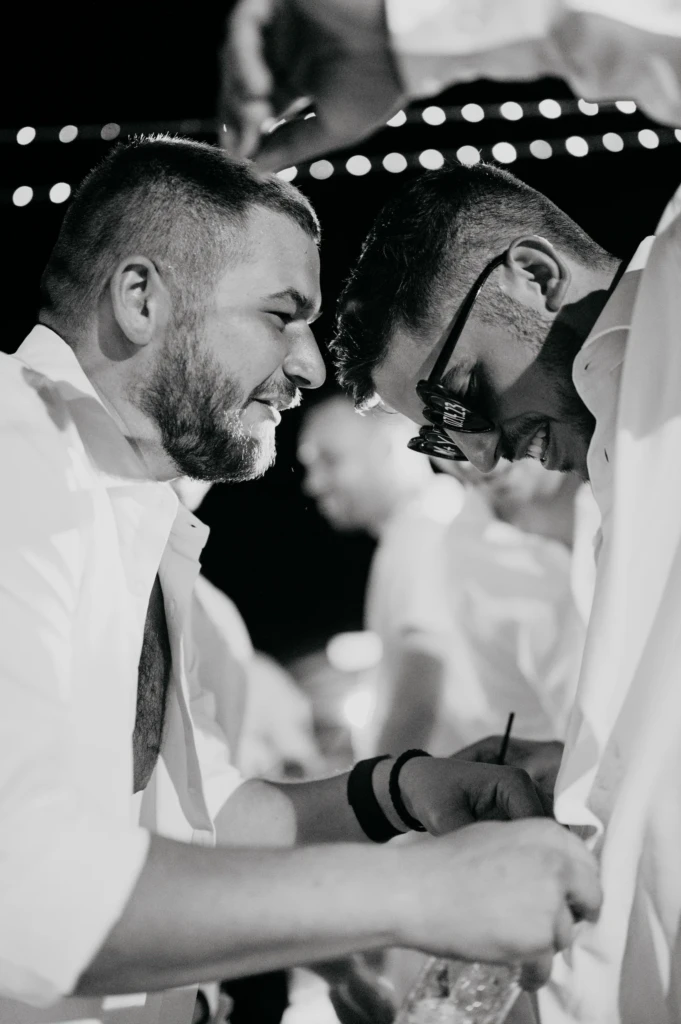 Two friends sharing an emotional moment at Maria and Giannis's wedding celebration in Thassos